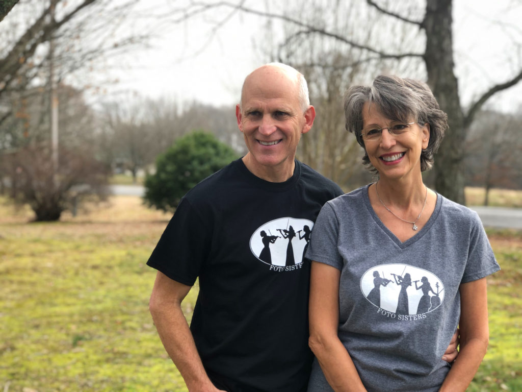 Two parents wear the custom t-shirts their children made