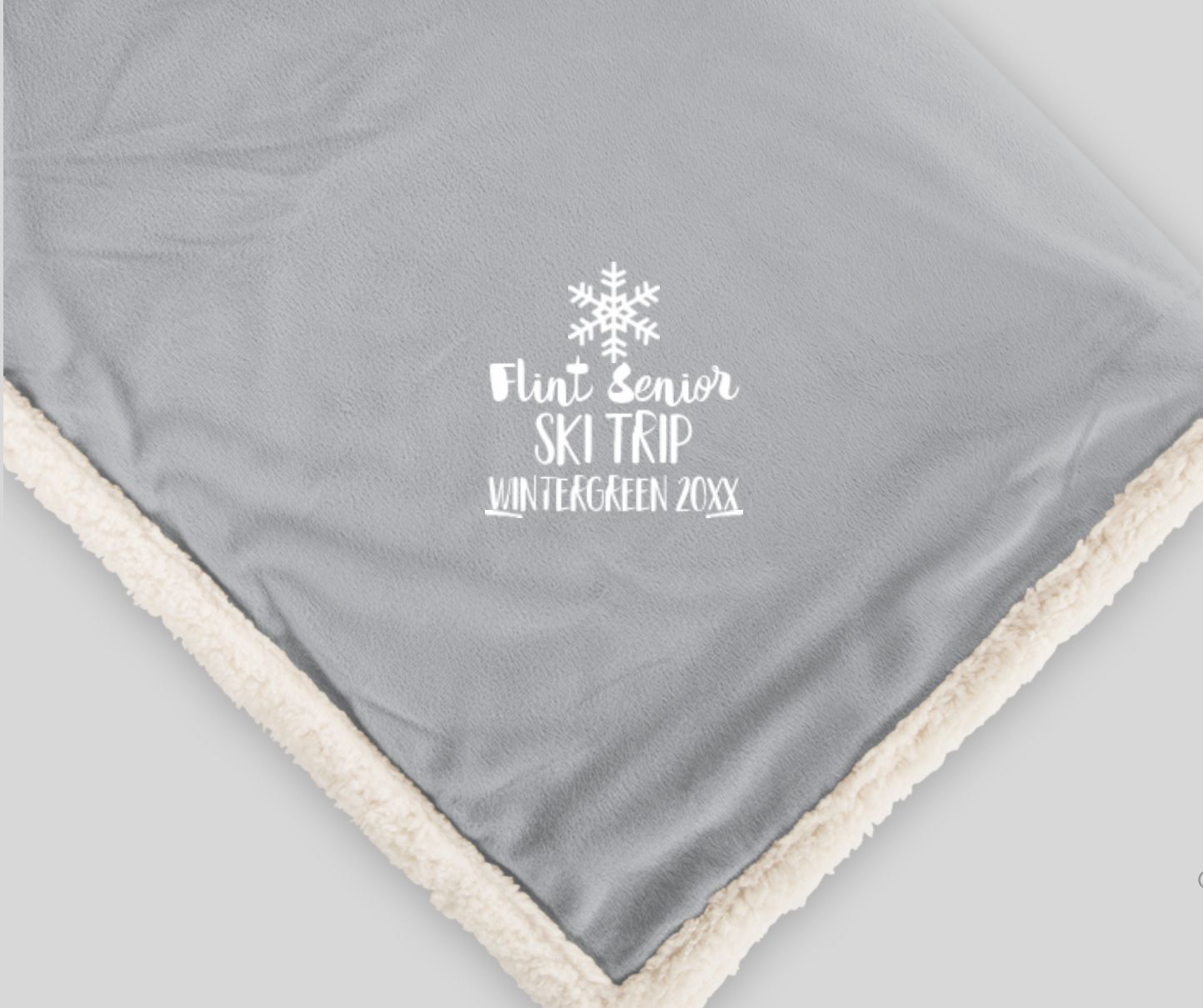 custom sherpa blanket with the words "flint senior ski trip wintergreen 20xx" and a snowflake
