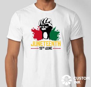 A white custom shirt with graphical elements featuring a raised fist and the text Juneteenth on it.
