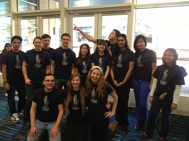 A Latin club shows off their custom t-shirts at a Latin Convention.
