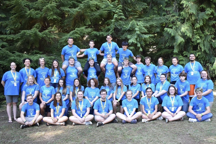A group of bible camp counselors wearing their matching custom t-shirts.