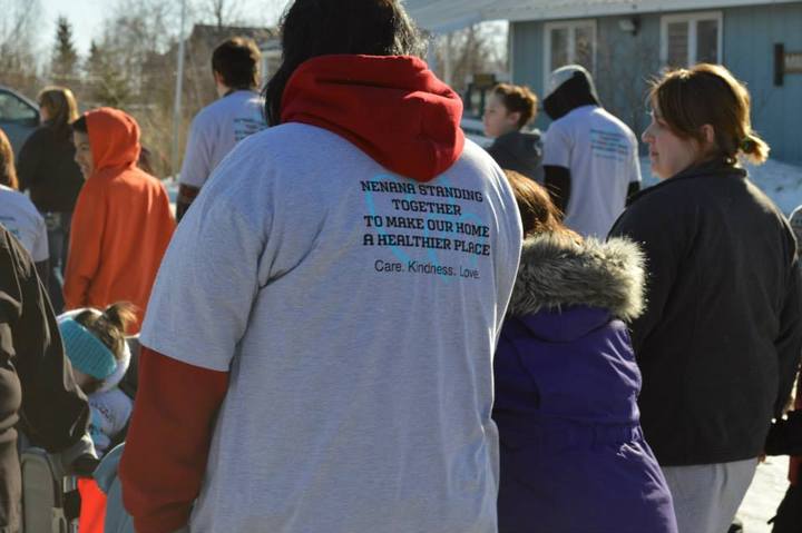 A group walks in matching custom t-shirts to end domestic violence by raising awareness