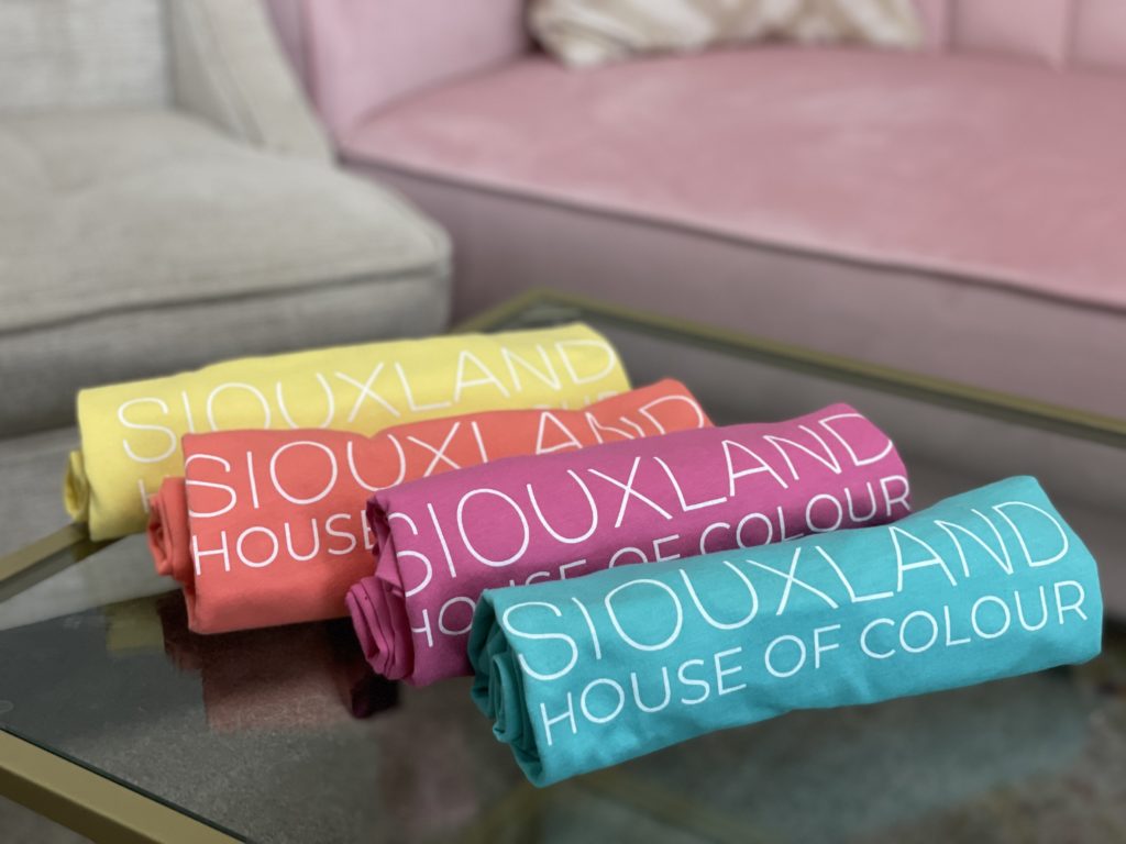 Row of folded Siouxland House of Color t-shirts