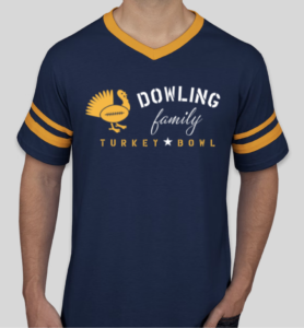 A navy and yellow v-neck t-shirt with a design that shows a turkey with a football for a body. Text reads "Dowling family Turkey Bowl." 