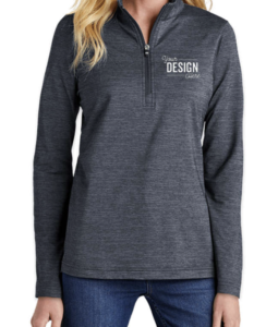 The TravisMathew Women's Crestview Performance Quarter Zip Sweatshirt in the color Vintage Indigo Heather is being worn by a woman and features "Your Design Here" on the left chest. 