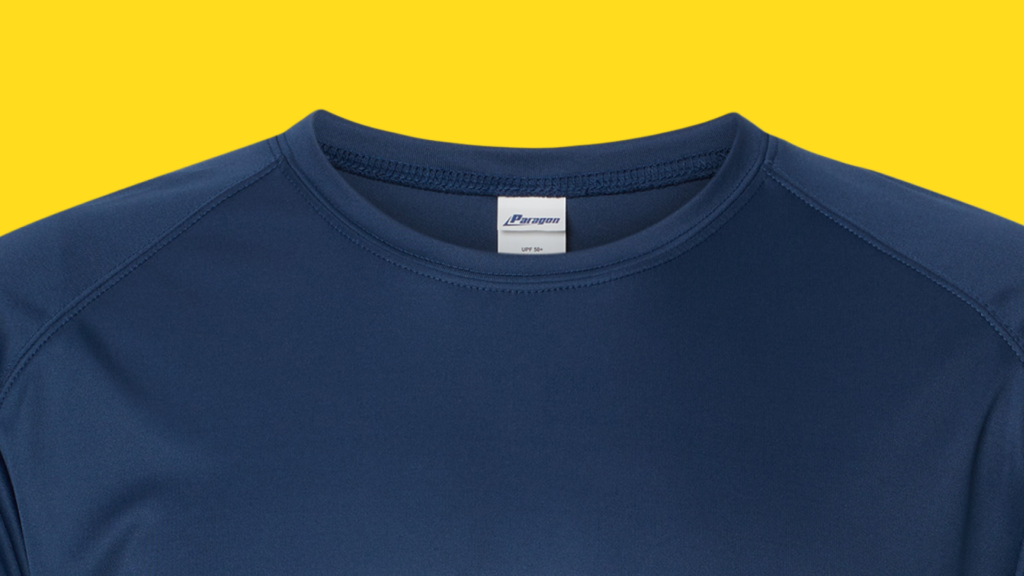 A close-up of the Paragon Islander UPF 50 Performance Shirt in navy from the shoulders up. The close stitching on this performance shirt protect your skin from UVA and UVB rays. 