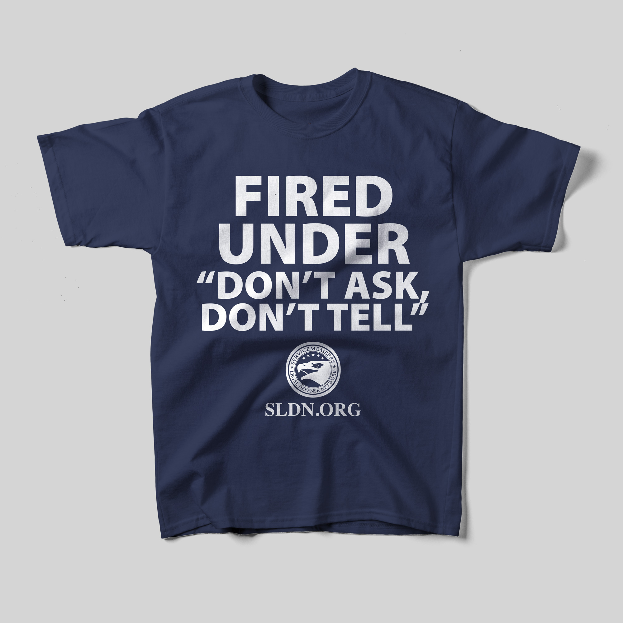 A navy blue shirt that reads, in white text, "Fired under 'Don't Ask, Don't Tell'" with the emblem for the Service Members Legal Defense Network and SLDN.org.
