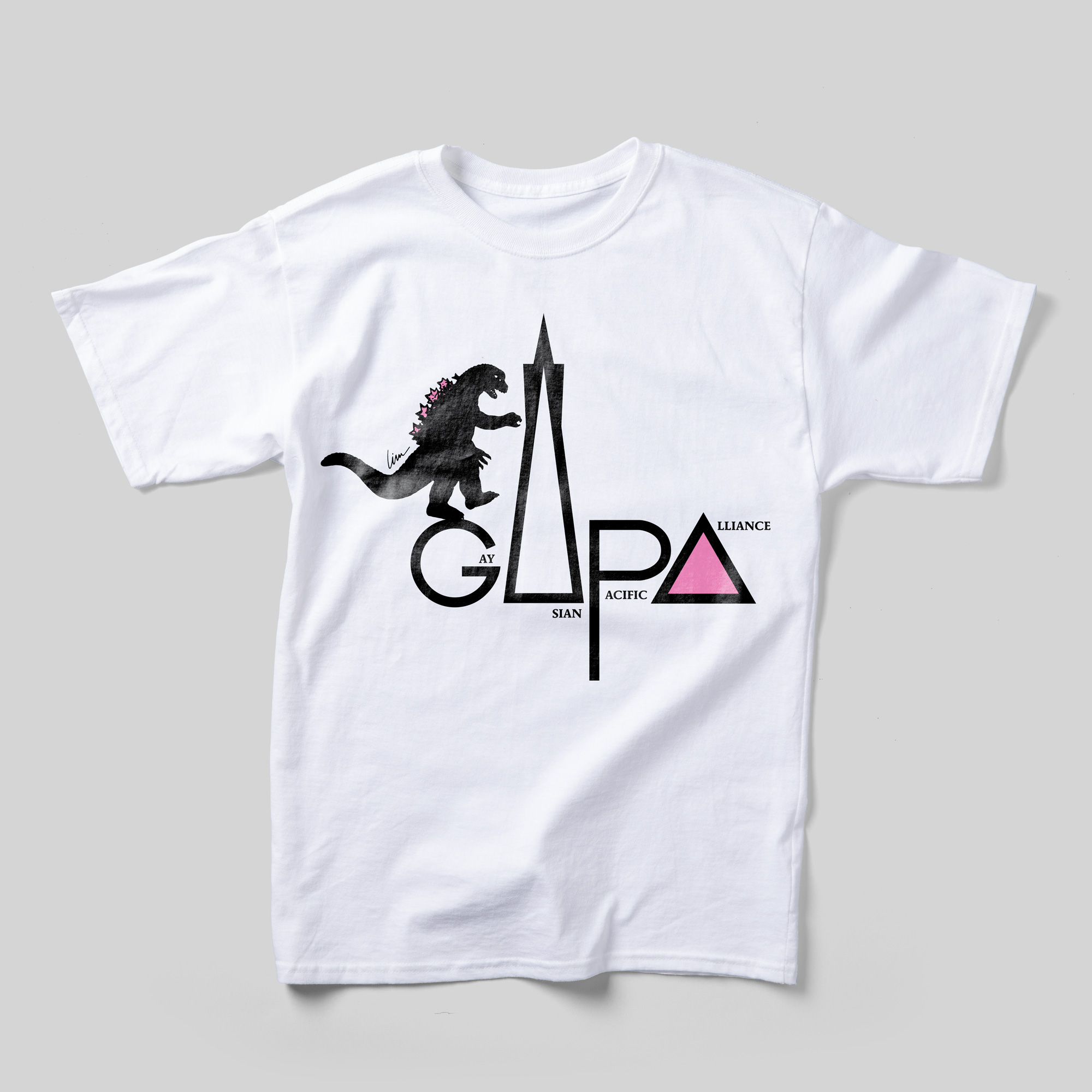 A white t-shirt with the Gay Asian Pacific Alliance logo. The "A" is a pink triangle. A solid black illustration of Godzilla is standing atop the "G."