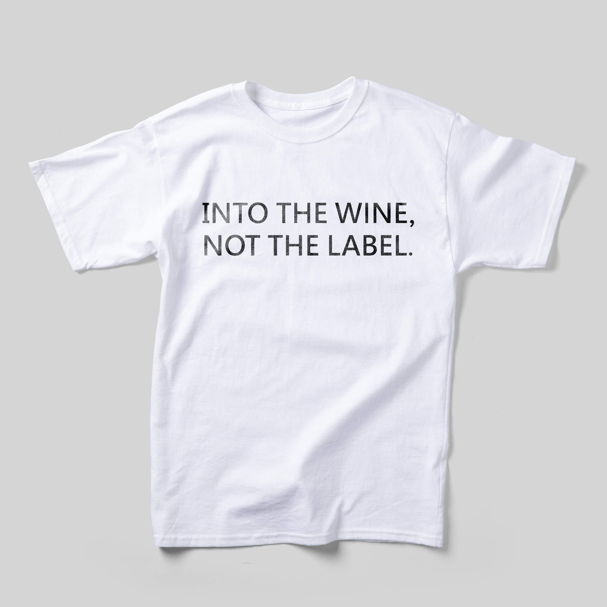 A white t-shirt that reads Into the wine, not the label in black text.