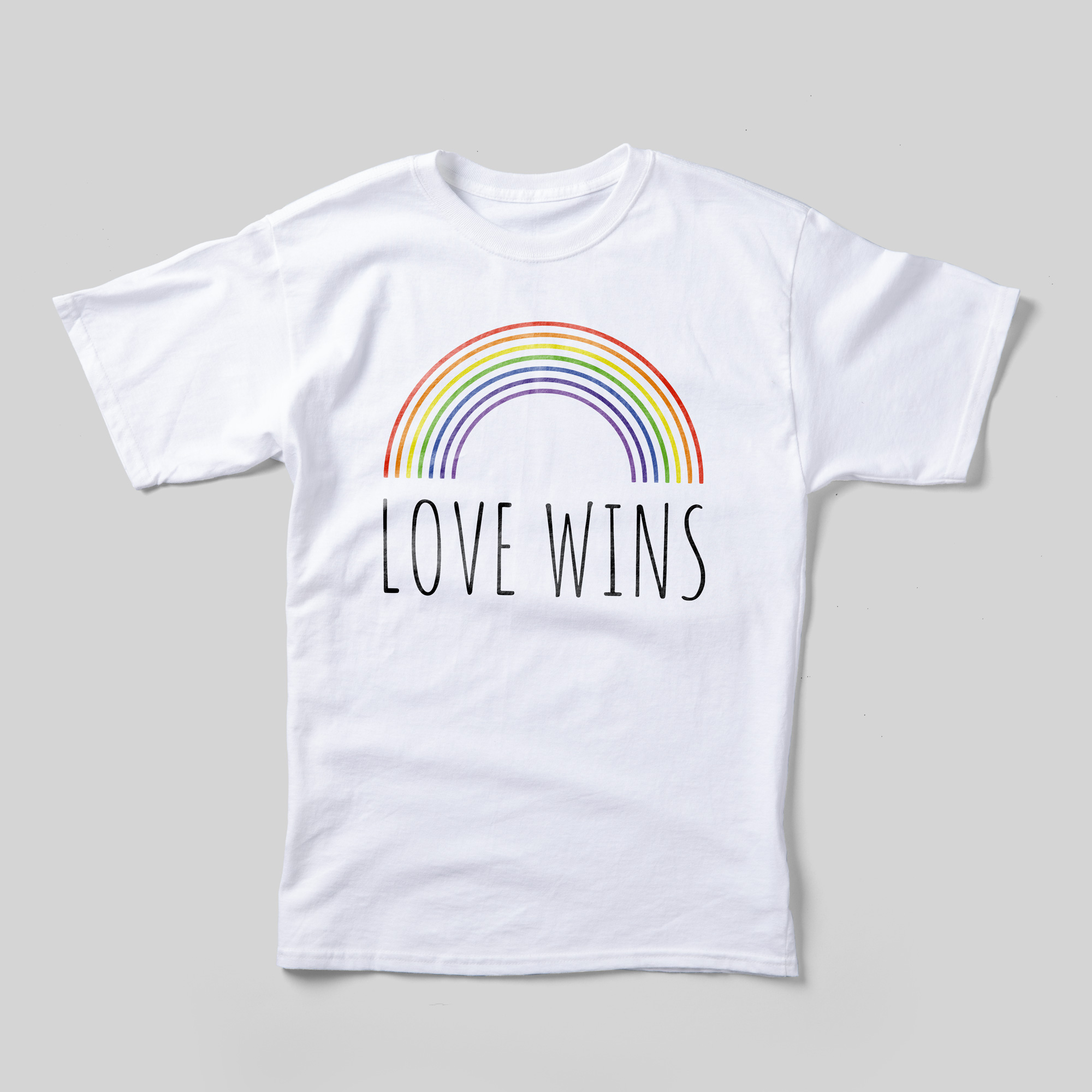 A white t-shirt that reads Love Wins in black with a rainbow above it.