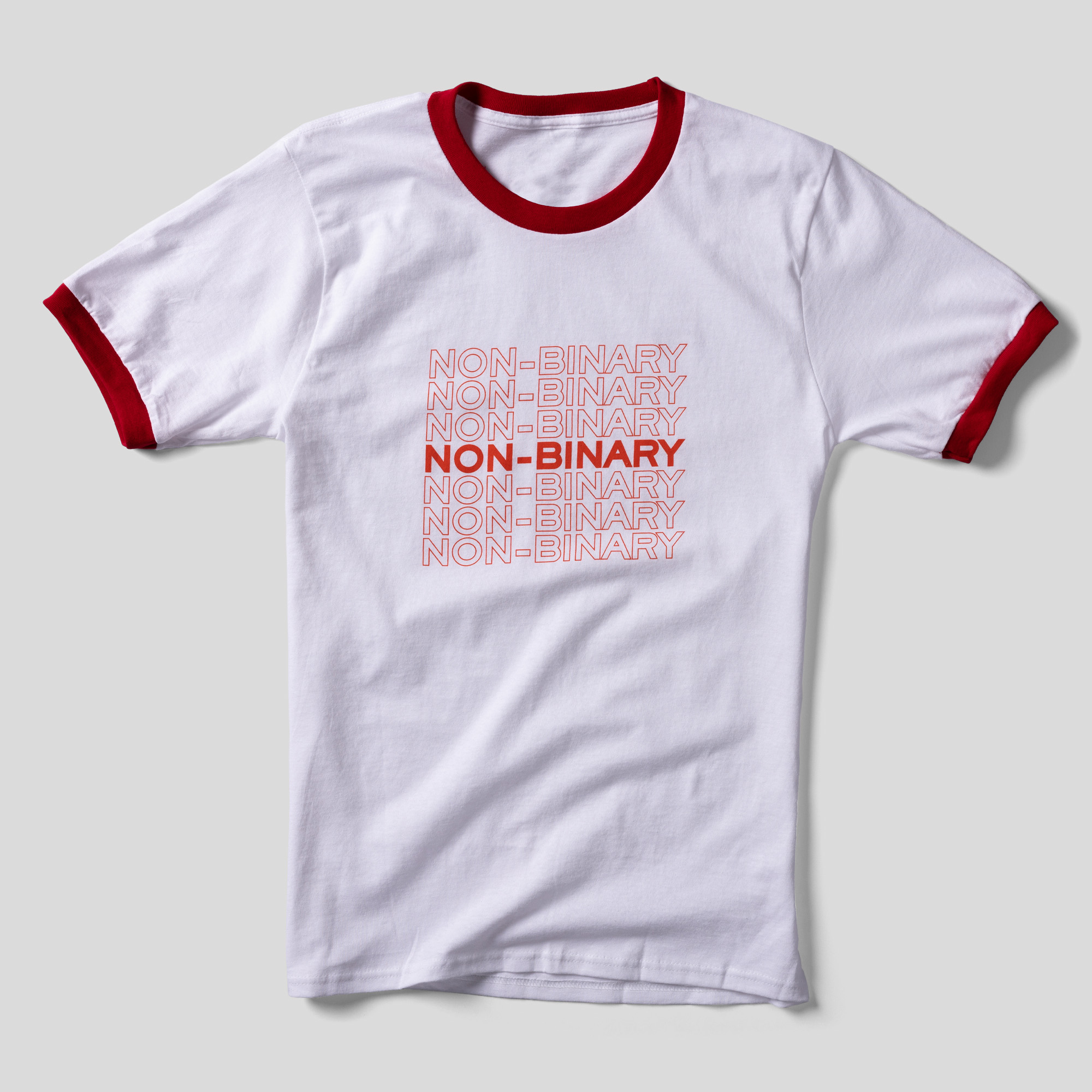 A white t-shirt with red-lined head and arm holes that says Non-Binary in both lined and solid red letters.