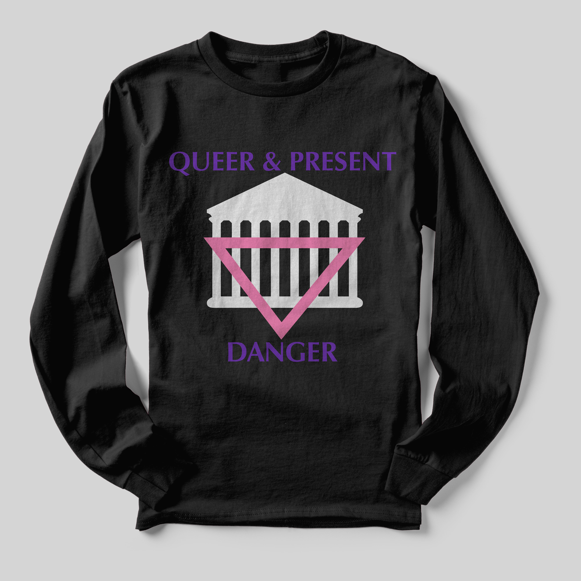 A black long-sleeved t-shirt that reads Queer & Present Danger in purple text and an illustration of the entrance to the Capitol Building with an upside-down pink triangle superimposed on it.