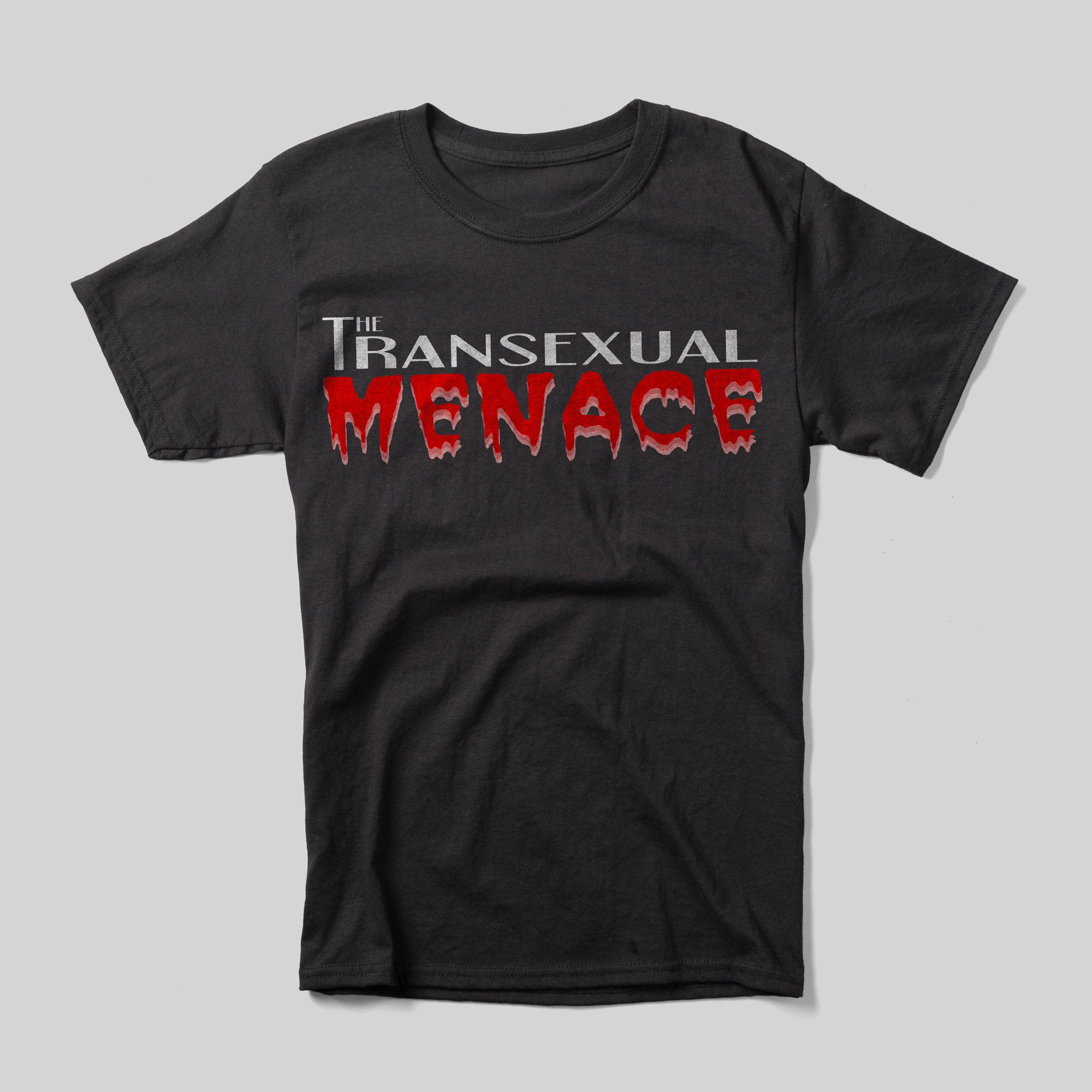 A black t-shirt that reads "The Transexual Menace." "The Transexual" is written in a gray all-caps font, while "Menace" is in "Double Feature" font, like it's written in blood. It is meant to resemble the title of "Rocky Horror Picture Show."