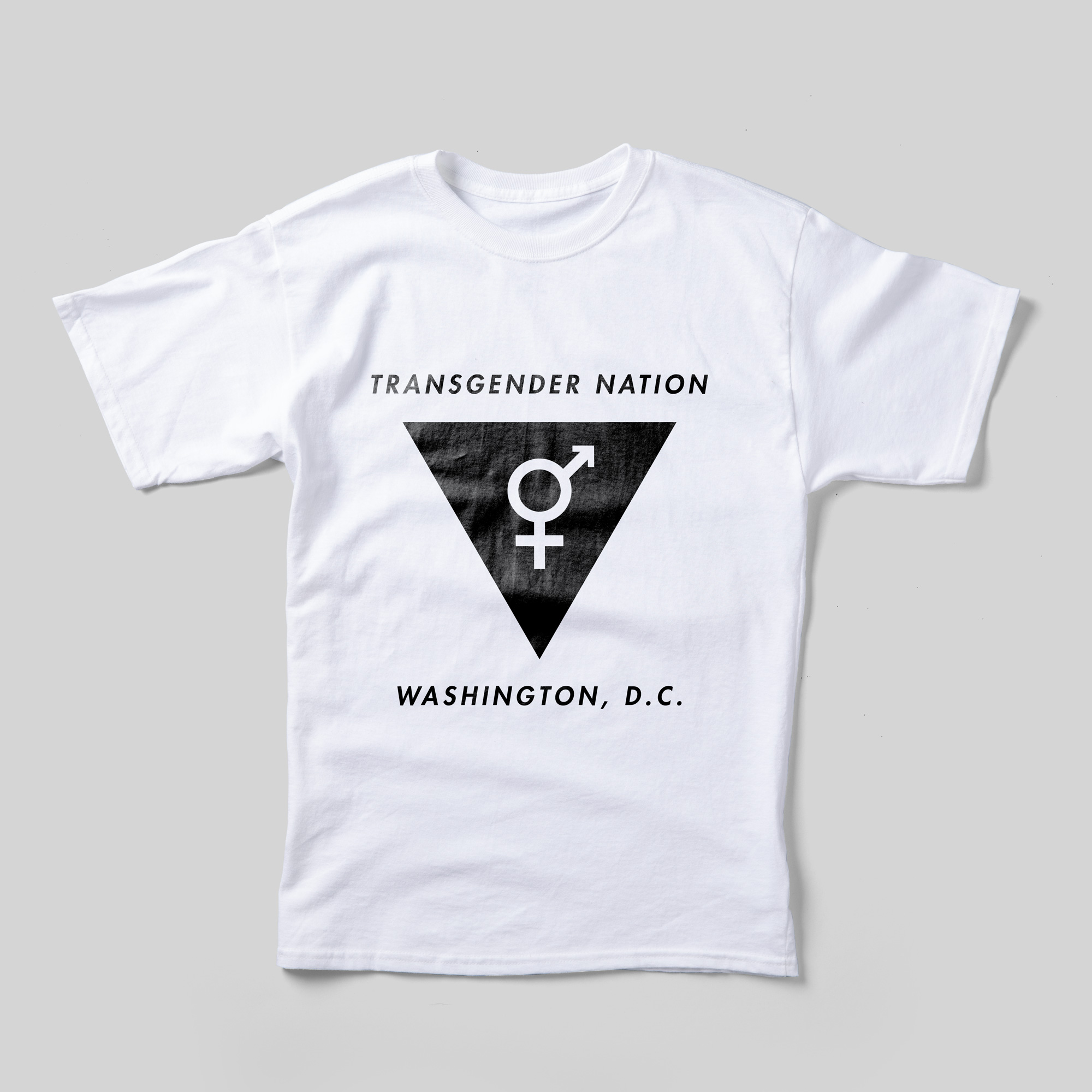 A white t-shirt that says, in black text, "Transgender Nation" at the top. Beneath it is a black upside-down triangle with the combined female-male symbol. Under the triangle is "Washington, D.C."