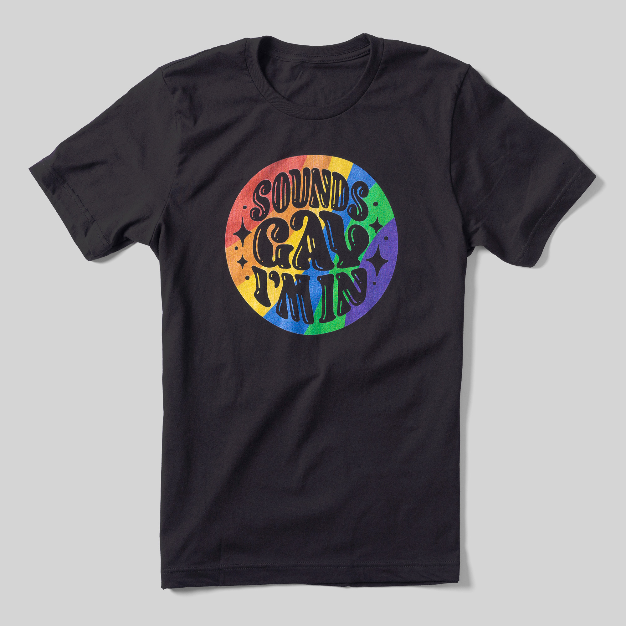 A black t-shirt that reads Sounds Gay, I'm In inside of a rainbow colored circle.