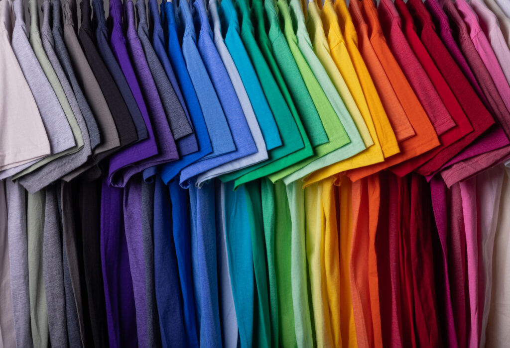 Custom t-shirt material comparison showing cotton, polyester, and tri-blend options