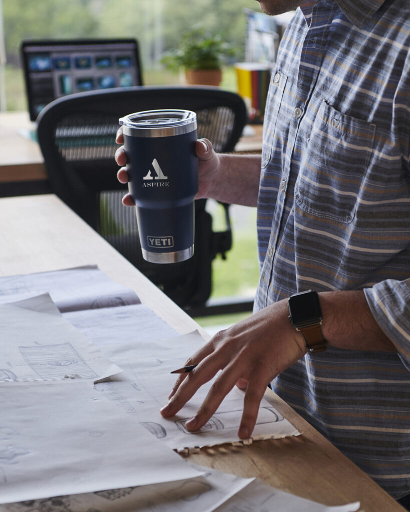 man holding a customized tumbler in an office