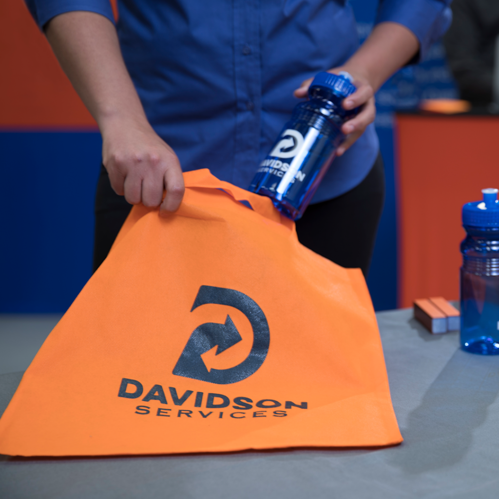 custom tote bag and water bottle at a trade show