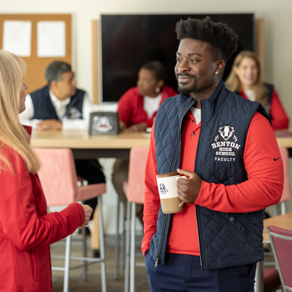 teachers wearing custom school apparel and drinking from personalized mugs